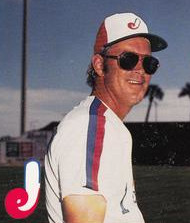 A baseball manager wearing a white uniform