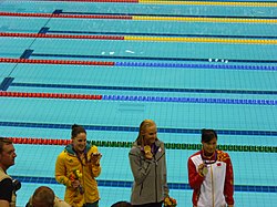 Alicia Coutts (vasemmalla) 100 metrin perhosuinnin palkintojenjaossa Lontoon olympialaisissa 2012.