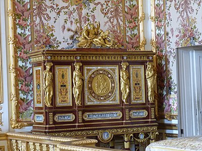 Louis XVI style caryatids with Ionic capitals on their heads, on a jewelry locket of Marie-Antoinette, by Ferdinand Schwerdfeger, 1787, mahogany, mother-of-pearl inlays, paintings under glass, porcelain plate, and gilded bronzes, Chambre de la Reine, Palace of Versailles, Versailles, France[31]