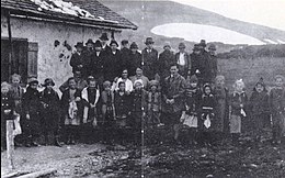 Photographie de classe, vieillie sur laquelle deux rangs d'élèves figurent, ainsi que leur instituteur septième en partant de la droite.