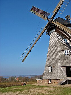 Windmill of Benz, with church and lake Schmollensee in the background