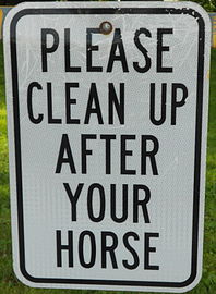 Sign in the township office parking lot on the hitching rail for Amish buggies