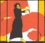 Graphik von historischem Plakat von 2014 von Karl Maria Stadler: Eine Frau mit schwarzem Haar und knöchellangem schwarzem Kleid, barfuß, schwingt eine viele Meter lange leuchtendrote Fahne, rechts und links wird das Bild durch zwei orangefarbige Säulen begrenzt