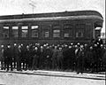 Railroad workers outside of the car.