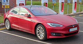 A front-three quarter view of a red Model S