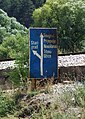 Old road sign in Serbia, pointing to Titograd and Titovo Užice