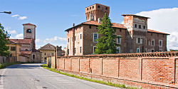 Two red buildings and a red brick fence.