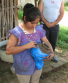 A woman cutting designs into unfired Barro Negro pottery in San Bartolo Coyotepec, Oaxaca, Mexico.