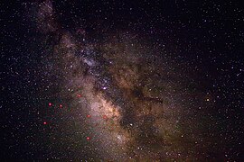 A view of the night sky near Sagittarius, enhanced to show better contrast and detail in the dust lanes. The principal stars in Sagittarius are indicated in red.