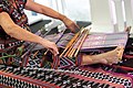 A traditional Vietnamese brocade and silk products weaver using a handloom