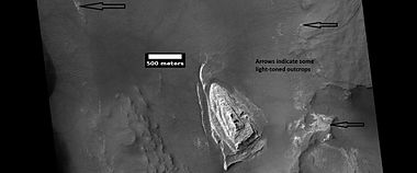 Light toned butte on floor of crater, as seen by HiRISE under HiWish program. Arrows show outcrops of light toned material. Light toned material is probably sulfate-rich and similar to material examined by Spirit Rover, and it once probably covered the whole floor. Other images below show enlargements of the butte. Location is Margaritifer Sinus quadrangle.