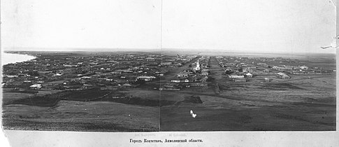 A 19th-century panorama view looking into the city of Kokshetau before rebuilding as seen from the Bukpa Hill Lookout. The Lake Kopa is visible to the left, and the St George's Church to the right.