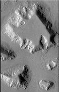 Mesa in Ismenius Lacus quadrangle, as seen by CTX. Mesa has several glaciers eroding it. One of the glaciers is seen in greater detail in the next two images from HiRISE. Image from Ismenius Lacus quadrangle.