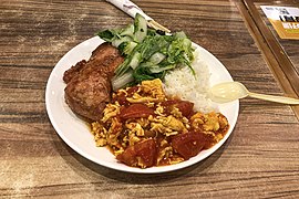 A serving of gaifan with three toppings sold from a food court in Beijing, China