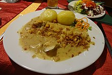 Stockfish with onion and bacon cream sauce and dumplings.