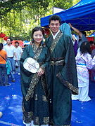 Hanfu enthusiasts in shenyi holding oblong-shaped tuanshan