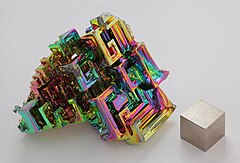 Bismuth, a synthetic crystal. Wikimedia Commons Featured photo by Alchemist-hp (talk) (www.pse-mendelejew.de).