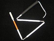 White cane with red band, folded into four segments