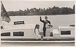 Prince Philip waves goodbye as he and Queen Elizabeth, accompanied by John Clunies-Ross, return to their ship from Home Island (1954).