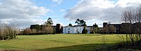 White, two-story house across a lawn