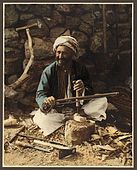 An American Colony Hand-coloured photography of a village carpenter.