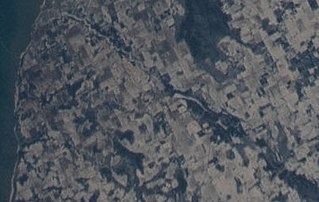 The Ahnapee River on February 7, 2022, taken from the International Space Station. The source of the river (lower right) is at the southeast of Gardner Swamp. The millpond at Forestville (center) appears as a long white spot. The river flows southwest towards its mouth at Algoma (upper left).