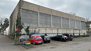 Das Gymnasium im Februar 2023, fotografiert vom Parkplatz der Schule mit Blick auf die Turnhalle.