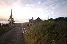 A road and a few buildings in West Helmsdale.