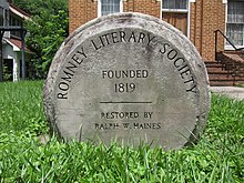 A round stone monument commemorating the establishment of the society