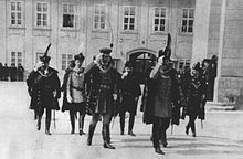 Group of people in formal garb, including swords