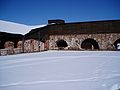 The inner yard of the fortress. To the left is the ruins of the western casemate and to the right is the restored northern casemate.