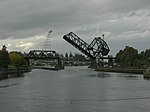 A bridge supported by trusses with a section of it raised