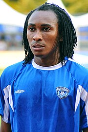 Photo of a player in blue football kit, hair braided.