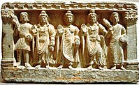 A Buddhist triad flanked by two pilasters with Indo-Corinthian capitals, Gandhara, 3rd century CE.