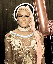 Photograph of a person wearing an outfit with many embellishments