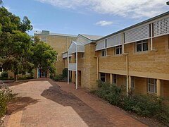 This is an image of a pathway surrounded by limestone buildings on the Joondalup campus.