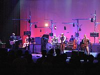Shows members of Modest Mouse performing in concert