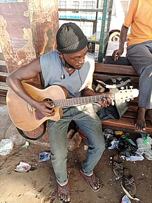 Photo of a man playing the guitar