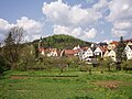 Blick aus dem Tal der Pegnitz (links) – mit Gebäuden der Stadt Pegnitz – zum Schloßberg mit seinem Aussichtsturm (von Ostsüdosten)