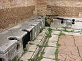 Image 25Public toilets (latrinae) from Ostia Antica (from Roman Empire)