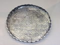 Silver dish with fluted rim. In the central medallion, a man pours a libation at a shrine