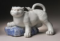 Okimono figurine in the form of a tiger climbing onto a rock, 19th century