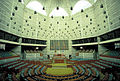 Image 16Jatiyo Sangsad Bhaban is the National Assembly Building of Bangladesh, located in the capital Dhaka. It was created by architect Louis I. Kahn and is one of the largest legislative complexes in the world. It houses all parliamentary activities of Bangladesh. This photo offers a view of the assembly hall inside the parliament building Photo Credit: Rossi101