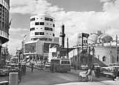 Photoghraph of the Murjan Mosque and the Abboud Building on the street by Latif al-Ani.