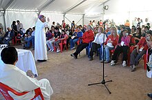 a priest offering mass for the workers and family members at San Jose Mine