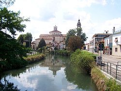 The bell tower of the Church of Saints Gervasio and Protasio visible form Via Italia in Gorgonzola