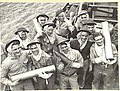 Australian gunners with cartridge cases and shell, January 1944