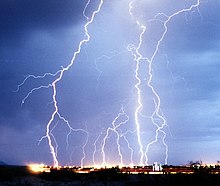 Multiple lightning strikes on a city at night