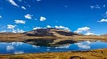 A lake in high-altitude area with sparse vegetation