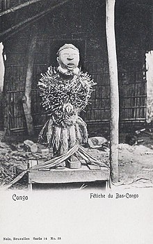 An anthropomorphic wooden statue with many nails driven into its torso.